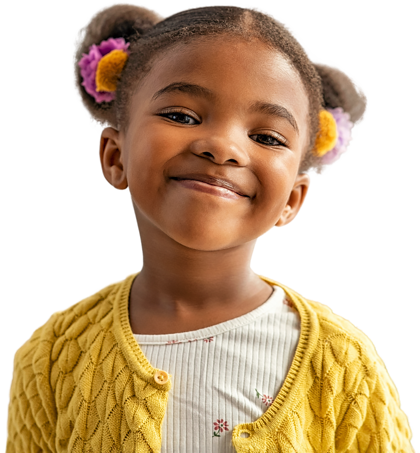 A young girl beams with happiness, showcasing her charming smile and cute hairstyle, exuding joy in a vibrant setting.