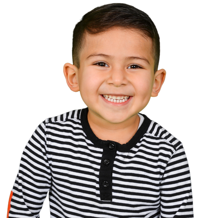 A young boy with a big smile wears a striped shirt, exuding joy in a bright and colorful setting.